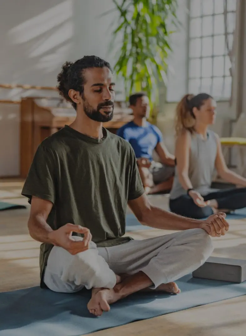 People meditating in a yoga class.